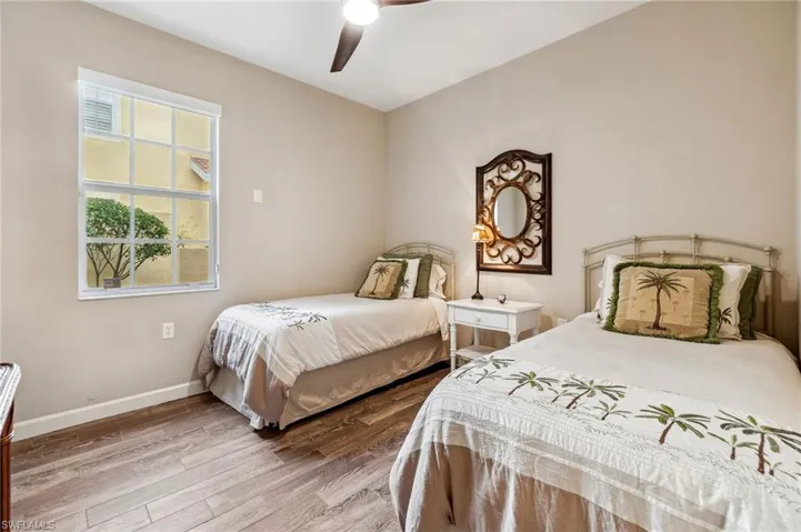 Bedroom with hardwood / wood-style flooring and ceiling fan