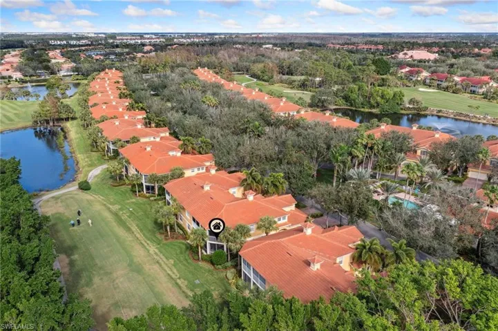 Birds eye view of property with a water view
