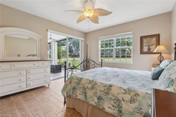 Bedroom with ceiling fan, access to exterior, and light hardwood / wood-style flooring