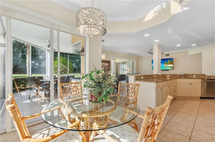 Dining space featuring crown molding, light tile patterned floors, and a notable chandelier