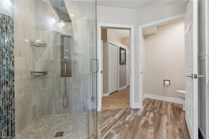 Bathroom featuring toilet and an enclosed shower