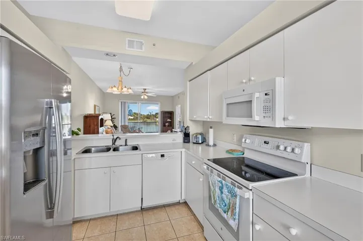 Kitchen with breakfast bar opening into the Living Room