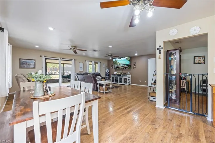 Dining space featuring baseboards, ceiling fan, recessed lighting, and light wood finished floors