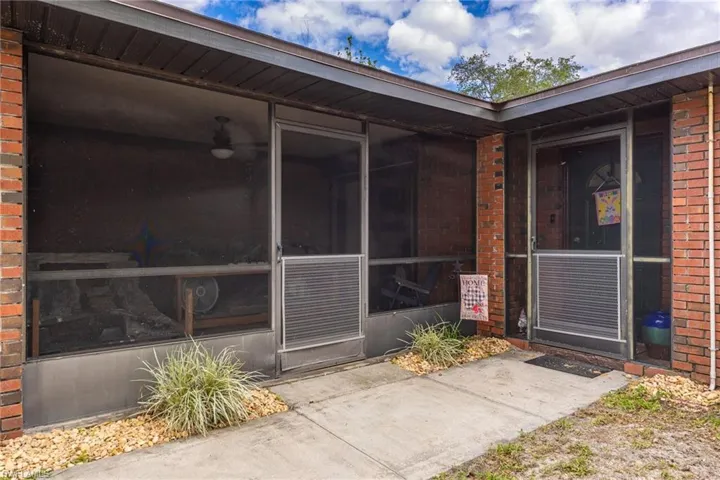 View of exterior entry with brick siding