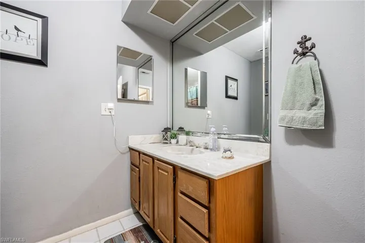 Guest Bathroom with baseboards and vanity