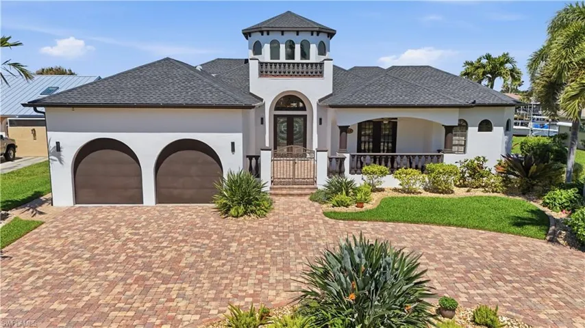 Mediterranean / spanish house with stucco siding, a garage, decorative driveway, and a shingled roof