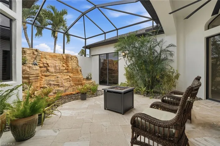 View of atrium with glass enclosure, a sunroom, and an outdoor fire pit