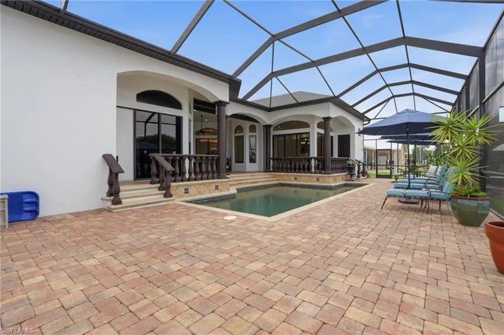 Swimming pool with a patio area, a lanai, and a sunroom