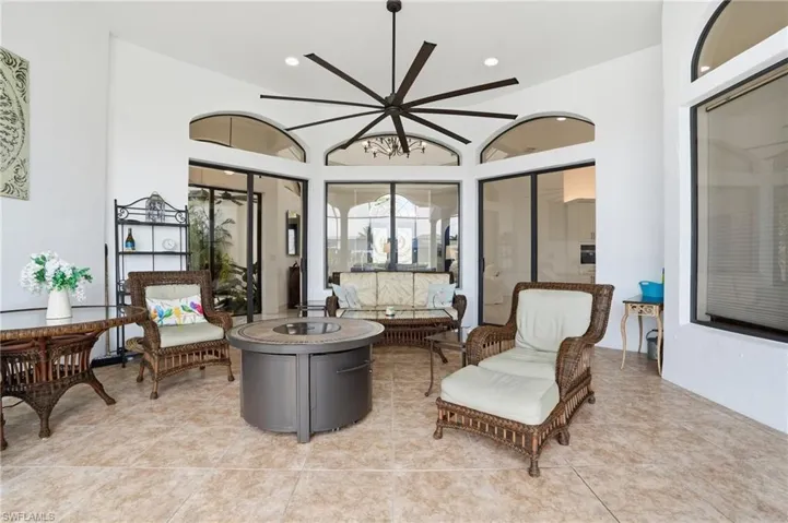 Living area with light tile patterned floors and recessed lighting