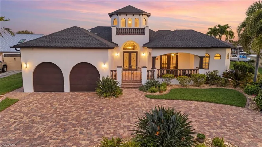 Mediterranean / spanish-style house featuring stucco siding, a garage, decorative driveway, and roof with shingles