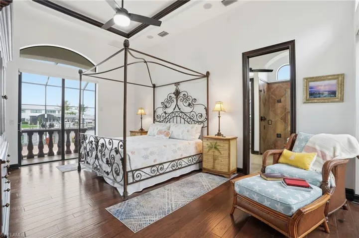 Bedroom featuring wood-type flooring, access to exterior, and ceiling fan