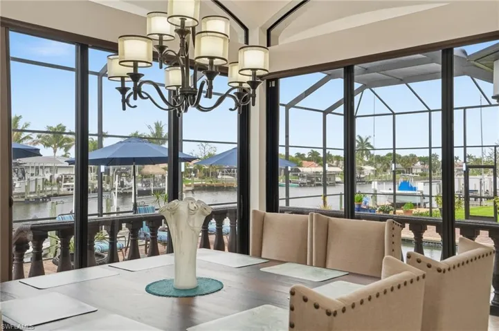 Dining room featuring a water view and suspended lighting