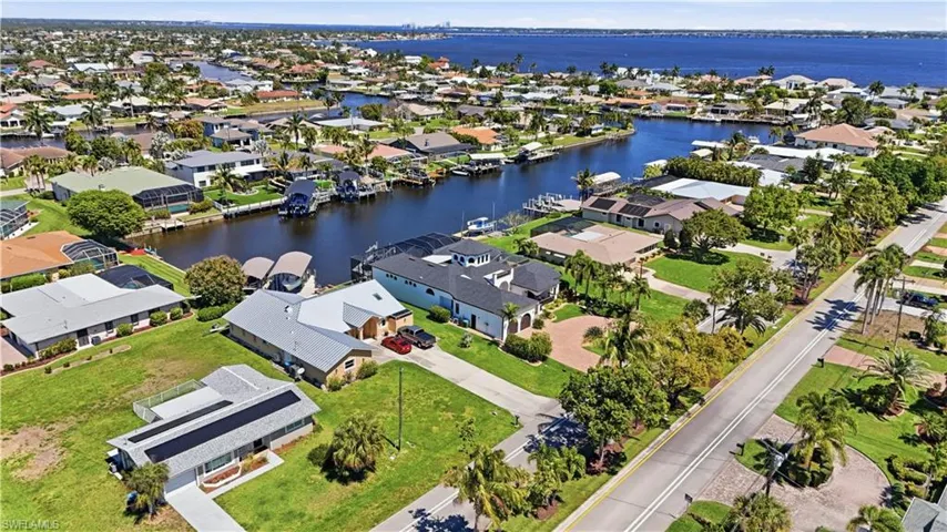 Aerial perspective of suburban area featuring a large body of water
