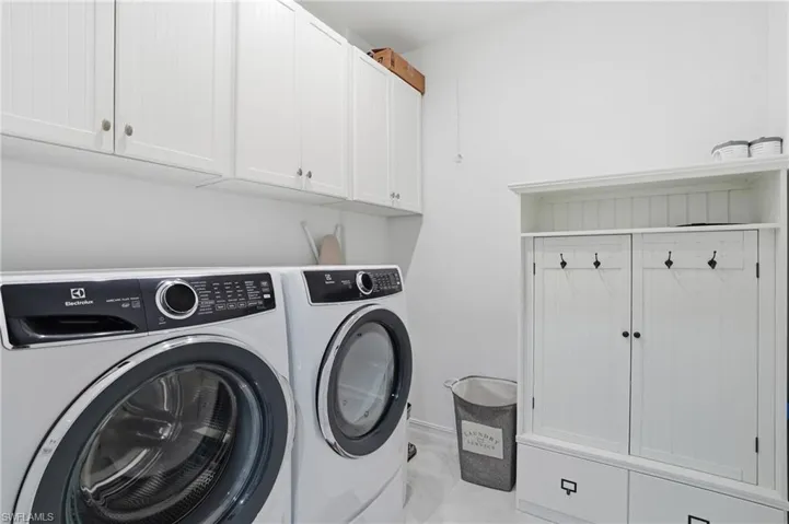 Laundry room featuring cabinet space and independent washer and dryer