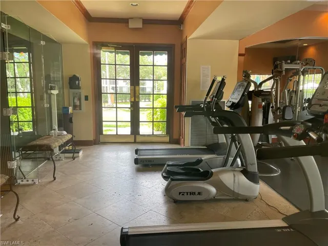 Gym featuring crown molding, french doors, and arched walkways