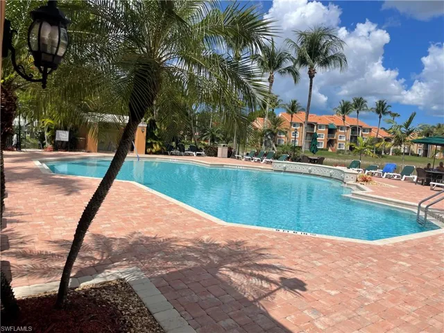 Community pool with a patio