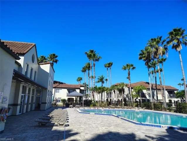 Community pool featuring a patio and a residential view