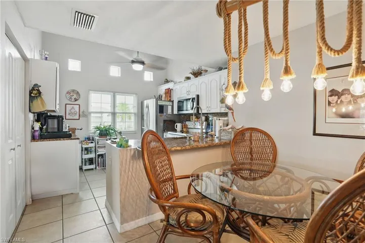 Dining area featuring ceiling fan and light tile patterned floors