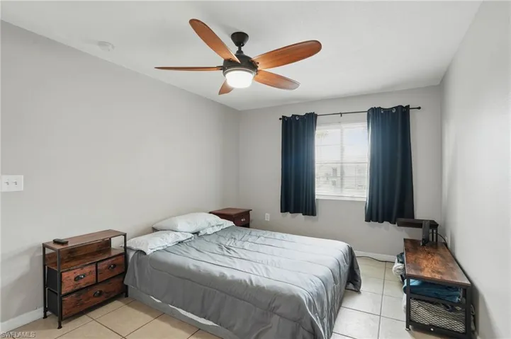 Bedroom featuring light tile patterned floors and a ceiling fan