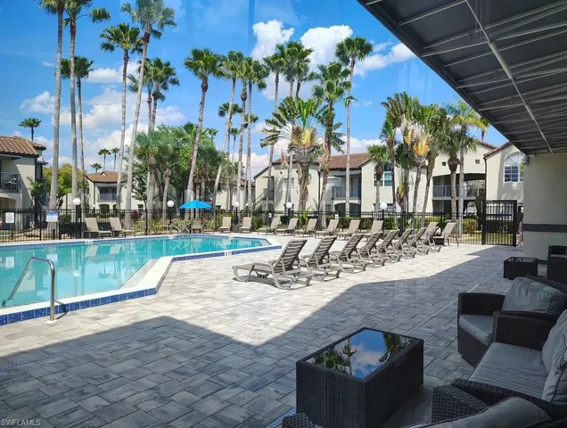Community pool featuring a patio and a residential view