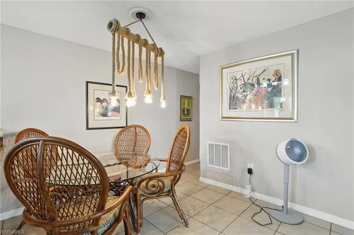 Dining space with light tile patterned floors and baseboards