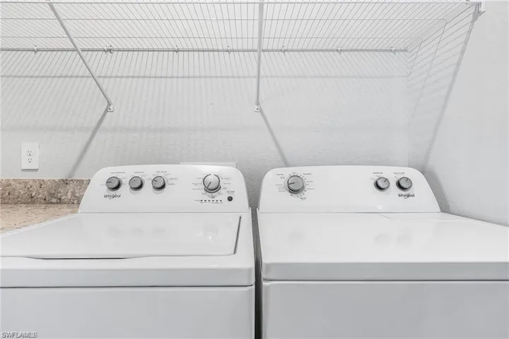 Laundry room with washer and clothes dryer