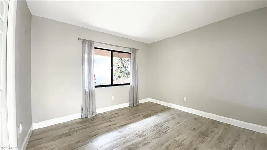 Spare room featuring wood-type flooring