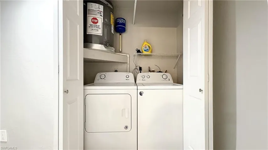 Laundry area with independent washer and dryer, hookup for an electric dryer, and electric water heater