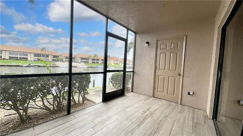 Unfurnished sunroom featuring a water view