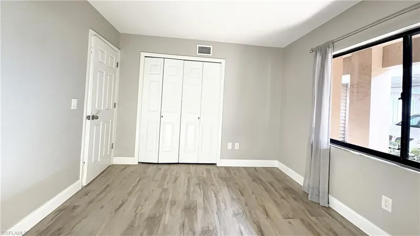 Unfurnished bedroom with a closet and light wood-type flooring