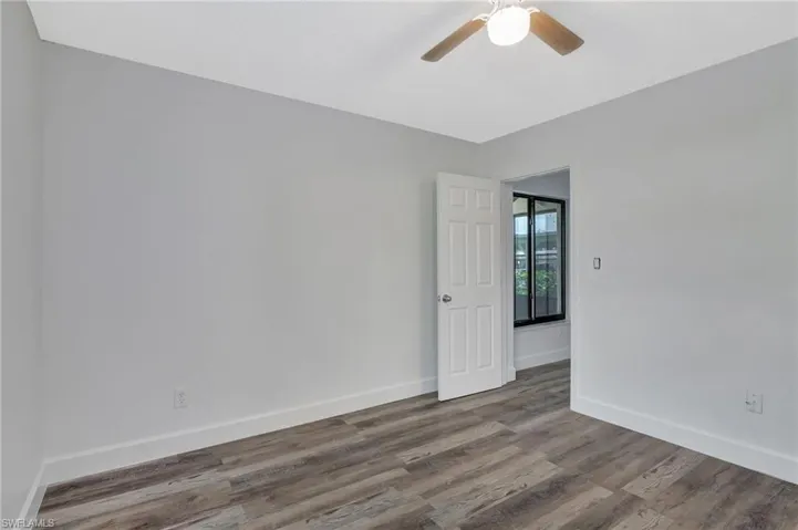 Unfurnished room with baseboards, wood finished floors, and ceiling fan
