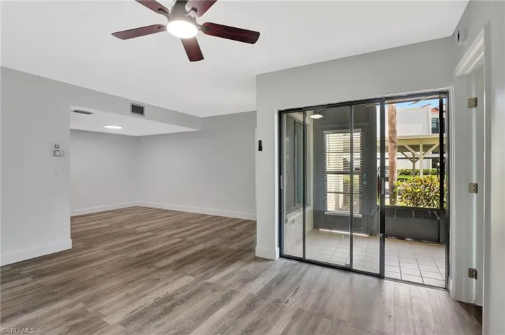 Spare room with ceiling fan, baseboards, wood finished floors, and visible vents