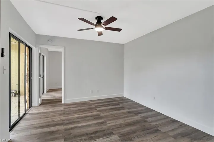Spare room featuring baseboards, a ceiling fan, and wood finished floors