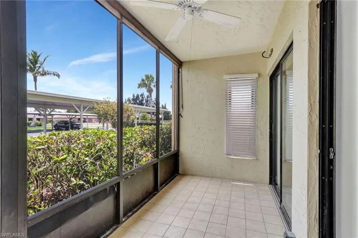 Unfurnished sunroom featuring ceiling fan