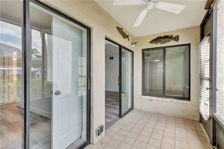 Unfurnished sunroom with plenty of natural light, visible vents, and a ceiling fan