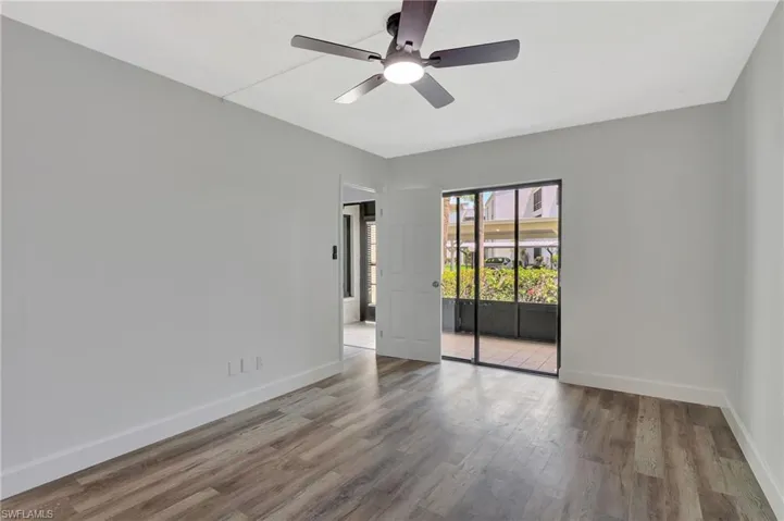 Unfurnished room with baseboards, a ceiling fan, and wood finished floors