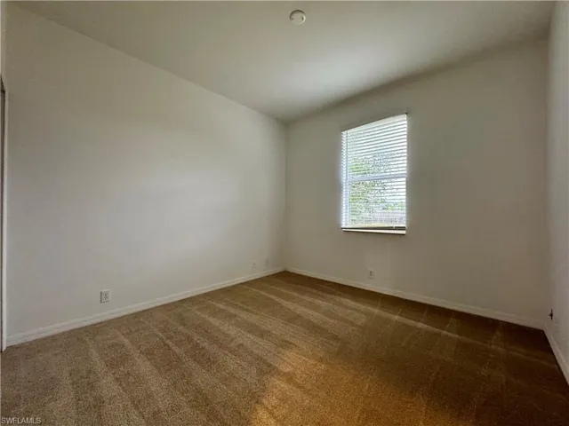 Unfurnished room featuring carpet