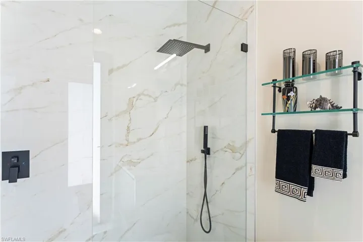 Bathroom with a marble finish shower