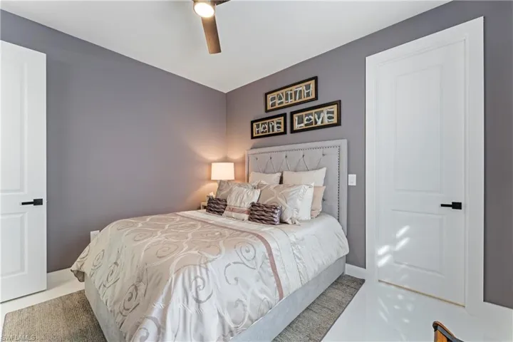 Bedroom with a ceiling fan and baseboards
