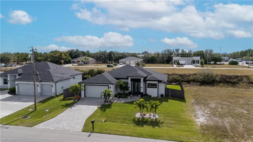 View of front of property featuring decorative driveway and a garage