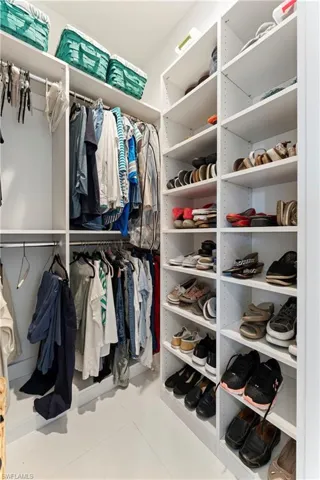 Spacious closet featuring light tile patterned floors