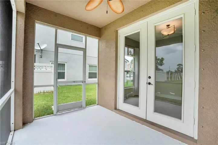 Sunroom with french doors, plenty of natural light, and ceiling fan