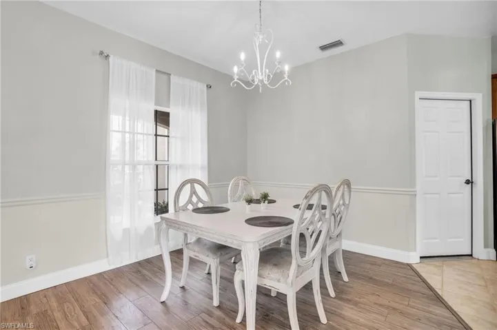 Dining room featuring hardwood / wood-style flooring and a notable chandelier
