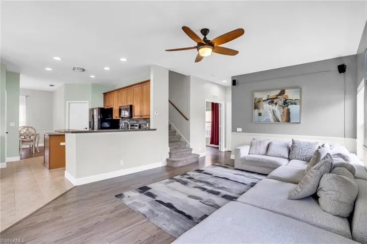 Living room featuring ceiling fan and light wood-type flooring