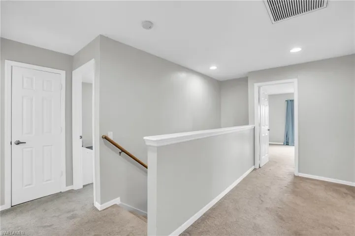 Hallway with light carpet