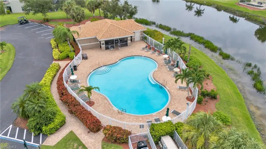 View of pool with a water view and a patio area