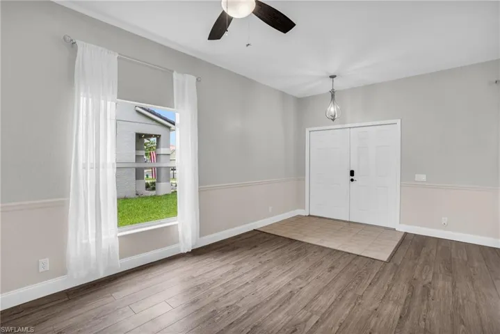 Entryway featuring ceiling fan and wood-type flooring