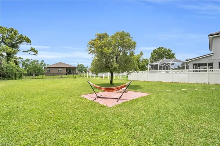 View of yard featuring glass enclosure and a patio area