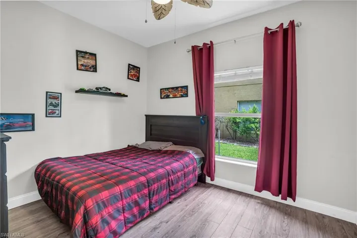 Bedroom featuring hardwood / wood-style flooring and ceiling fan