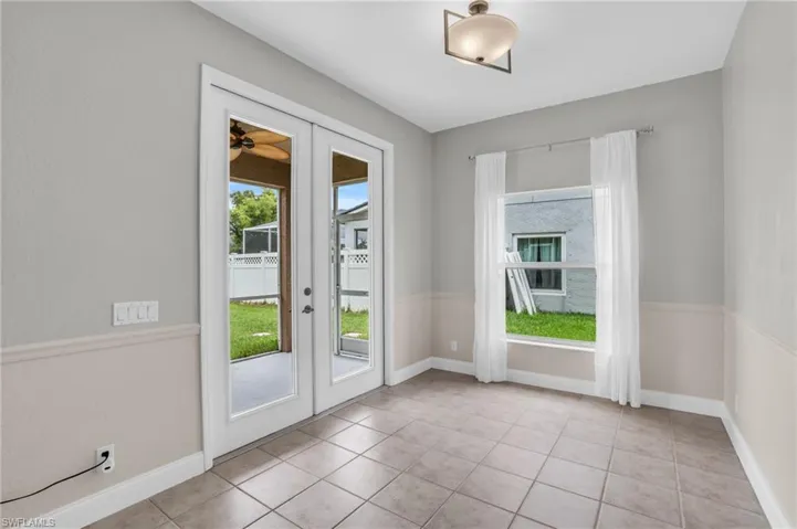 Doorway to outside with french doors and light tile patterned floors